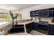Stylish kitchen featuring stainless steel appliances, dark cabinets, and view to the outside at 12642 N Mountainside Dr # B, Fountain Hills, AZ 85268
