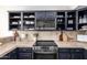 A stylish kitchen featuring dark blue cabinets, stainless steel appliances, and stone countertops at 12642 N Mountainside Dr # B, Fountain Hills, AZ 85268