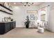 Bright sitting area with decorative shelving, sleek black bar, and modern chandelier at 12642 N Mountainside Dr # B, Fountain Hills, AZ 85268