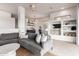 Cozy living room featuring a gray sectional sofa, accent pillows, and adjacent open shelving at 12642 N Mountainside Dr # B, Fountain Hills, AZ 85268