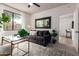 Bright living room featuring a comfortable sofa, modern decor, and access to other areas of the home at 12642 N Mountainside Dr # B, Fountain Hills, AZ 85268