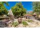 Secluded backyard oasis with stone patio, hot tub, dining area, and desert landscaping at 12837 N 68Th St, Scottsdale, AZ 85254