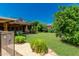 Expansive backyard featuring lush lawn, mature trees, and an upper deck with spiral staircase at 12837 N 68Th St, Scottsdale, AZ 85254