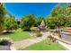 Serene backyard with manicured lawn, mature trees, and a cozy patio area with outdoor seating and a hot tub at 12837 N 68Th St, Scottsdale, AZ 85254