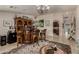 Elegant bar area with custom cabinetry, a chandelier, and views into the kitchen at 12837 N 68Th St, Scottsdale, AZ 85254