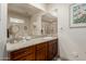 This bathroom vanity features granite countertops, a single sink, wood cabinets, and a large mirror at 12837 N 68Th St, Scottsdale, AZ 85254