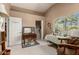Neutral bedroom with vaulted ceiling, a closet and view of yard through the window at 12837 N 68Th St, Scottsdale, AZ 85254