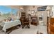 Neutral bedroom with a window, rocker, books, and decorative items at 12837 N 68Th St, Scottsdale, AZ 85254