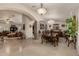 Spacious dining area with elegant lighting, arched entrances, and seamless flow to the living room at 12837 N 68Th St, Scottsdale, AZ 85254