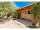 Charming front entrance with stone pathway, inviting porch, and lush greenery, creating a welcoming curb appeal at 12837 N 68Th St, Scottsdale, AZ 85254