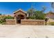 Inviting home featuring a stone-accented courtyard and a covered entrance, nestled behind desert landscaping at 12837 N 68Th St, Scottsdale, AZ 85254