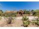 Charming single-story home with desert landscaping, a cozy courtyard, and a warm, inviting exterior at 12837 N 68Th St, Scottsdale, AZ 85254