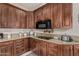 Close up of the kitchen area showcasing granite counters, dark cabinetry, and modern appliances at 12837 N 68Th St, Scottsdale, AZ 85254