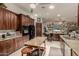 Open concept kitchen with dark wood cabinetry, granite countertops, and stainless steel appliances at 12837 N 68Th St, Scottsdale, AZ 85254