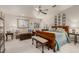 This main bedroom features a sitting area, carpeted floors, and a ceiling fan at 12837 N 68Th St, Scottsdale, AZ 85254