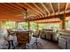 Beautiful outdoor kitchen and dining area with fire table, ceiling fan, and bar seating at 12837 N 68Th St, Scottsdale, AZ 85254