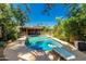 Gorgeous pool with diving board, mature trees, and a covered patio area with outdoor seating at 12837 N 68Th St, Scottsdale, AZ 85254
