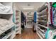 This walk-in closet has wooden floors, shelving on either side, and ample storage at 12837 N 68Th St, Scottsdale, AZ 85254
