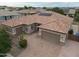 Beautiful single-story home featuring a tile roof, a three car garage, and a brick paver driveway at 14376 W Desert Hills Dr, Surprise, AZ 85379