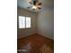 Sunlit bedroom with shuttered windows and a ceiling fan at 14376 W Desert Hills Dr, Surprise, AZ 85379