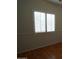 A close view of a bedroom with shuttered windows and light fixture at 14376 W Desert Hills Dr, Surprise, AZ 85379