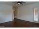 Large bedroom with dark wood floors and a ceiling fan at 14376 W Desert Hills Dr, Surprise, AZ 85379