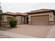 Attractive home with a three car garage and desert landscaping at 14376 W Desert Hills Dr, Surprise, AZ 85379