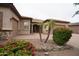 Charming front yard features desert landscaping, a paver walkway, and a two car garage at 14376 W Desert Hills Dr, Surprise, AZ 85379