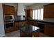 Gourmet kitchen with granite countertops and stainless steel appliances at 14376 W Desert Hills Dr, Surprise, AZ 85379