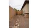 Home exterior showing gravel side yard with stone detail and gate at 14376 W Desert Hills Dr, Surprise, AZ 85379