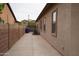 Home exterior featuring a side yard with neutral stucco and windows at 14376 W Desert Hills Dr, Surprise, AZ 85379