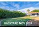 Expansive backyard with healthy green lawn and privacy hedge around the property at 1622 N 17Th Ave, Phoenix, AZ 85007