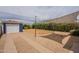 Backyard showcasing gravel drive, shade structure, storage building, and landscaping at 1622 N 17Th Ave, Phoenix, AZ 85007