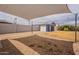 Spacious backyard featuring a covered patio, stone landscaping, block wall, and a detached garage at 1622 N 17Th Ave, Phoenix, AZ 85007