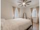 Bright bedroom with a large bed frame, ceiling fan, and natural light from multiple windows at 1622 N 17Th Ave, Phoenix, AZ 85007