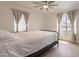 Well-lit bedroom featuring neutral walls, light wood floors, a ceiling fan, and two large windows at 1622 N 17Th Ave, Phoenix, AZ 85007