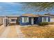 Charming blue home featuring white trim accents, a mature tree, and a driveway leading to a carport at 1622 N 17Th Ave, Phoenix, AZ 85007