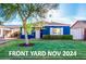Charming blue home with green lawn, trimmed hedges, and a beautiful shade tree at 1622 N 17Th Ave, Phoenix, AZ 85007