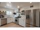 Bright kitchen features stainless steel appliances, white cabinets, and a window over the sink at 1622 N 17Th Ave, Phoenix, AZ 85007