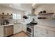 Modern kitchen boasts stainless steel appliances, open shelving, and contemporary design at 1622 N 17Th Ave, Phoenix, AZ 85007
