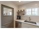 Kitchen featuring stainless steel appliances, a laundry door, and a garden window at 1622 N 17Th Ave, Phoenix, AZ 85007