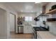 Bright kitchen featuring stainless steel appliances, open shelving, and modern fixtures at 1622 N 17Th Ave, Phoenix, AZ 85007