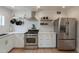 Well-equipped kitchen with stainless steel appliances and white cabinets offers a modern design at 1622 N 17Th Ave, Phoenix, AZ 85007