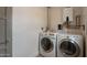 Functional laundry room with side-by-side washer and dryer units and a tankless water heater at 1622 N 17Th Ave, Phoenix, AZ 85007