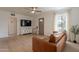 Bright living room featuring a leather sofa, TV, and a front door at 1622 N 17Th Ave, Phoenix, AZ 85007