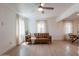 Bright living room with wood-look flooring, neutral paint, ample light and a leather couch at 1622 N 17Th Ave, Phoenix, AZ 85007