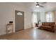 Bright living room with wood-look flooring, neutral paint, ample light and a leather couch at 1622 N 17Th Ave, Phoenix, AZ 85007