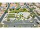 Stunning aerial view showcasing community amenities: pool, spa, lawn bowling, and clubhouse with convenient parking at 18226 W Stinson Dr, Surprise, AZ 85374