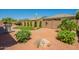 Expansive backyard with desert landscaping, mature trees, and a built-in grill, perfect for outdoor entertaining at 18226 W Stinson Dr, Surprise, AZ 85374