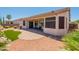 Large backyard features a covered patio, barbecue grill, desert landscaping, and an artificial turf area at 18226 W Stinson Dr, Surprise, AZ 85374